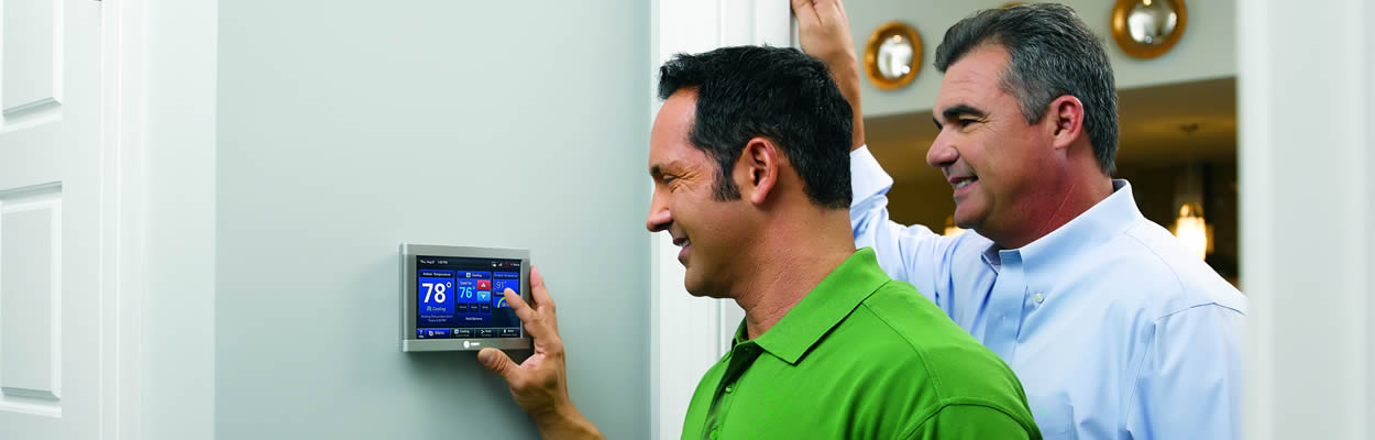 trane tech showing customer how to use their smart thermostat
